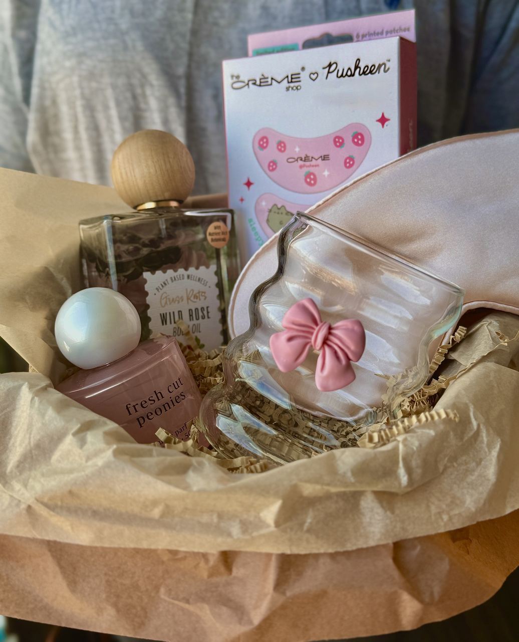 Pink self-care basket with perfume and bow glass
