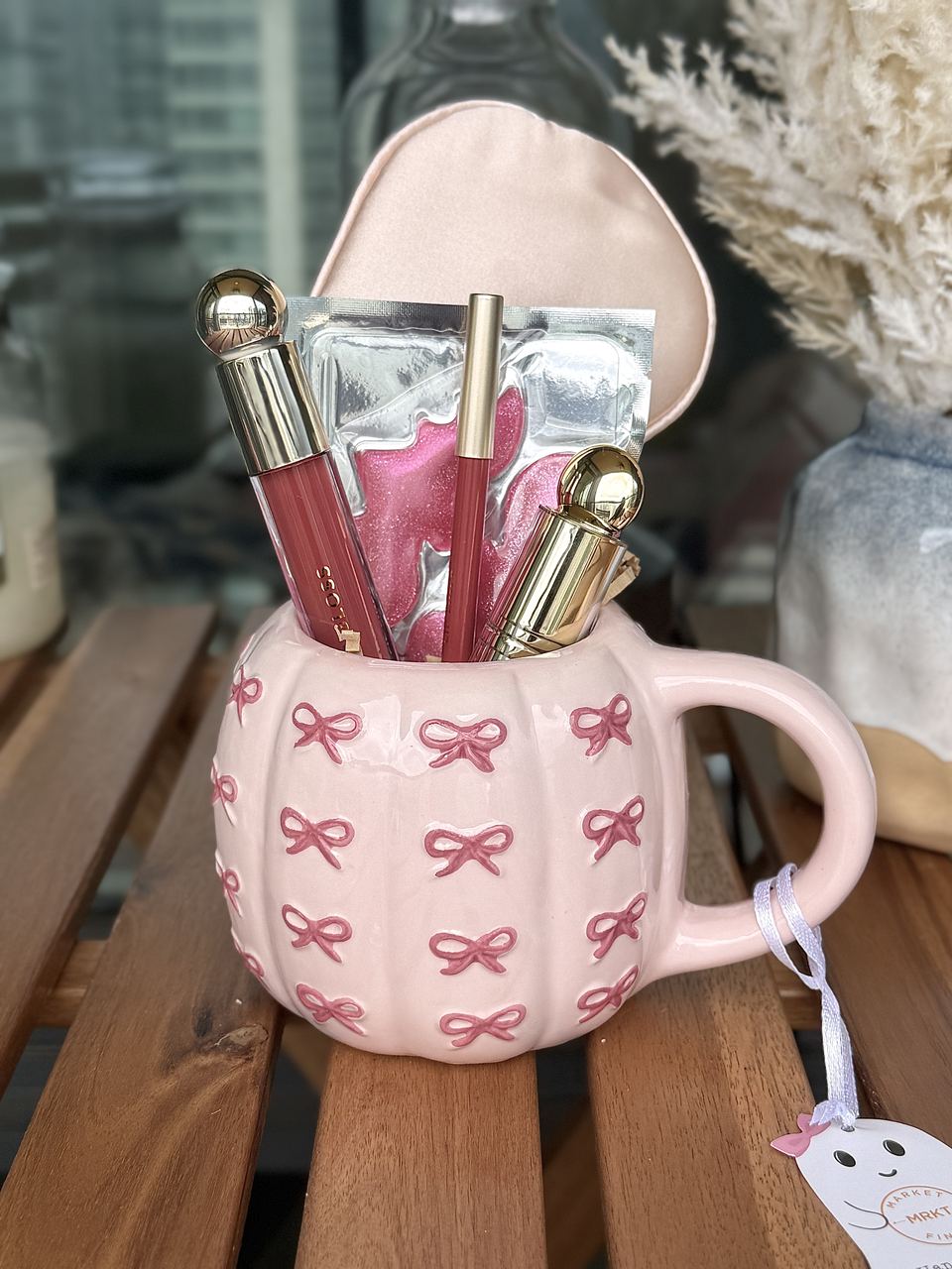 Pink bow mug filled with beauty treats