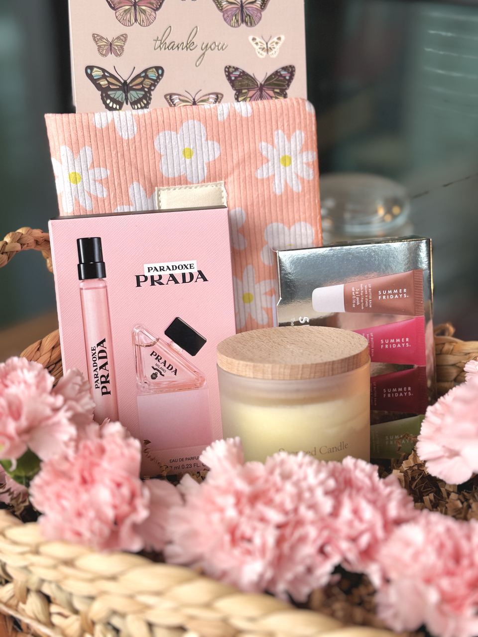 Prada fragrance and Summer Fridays products in a floral basket
