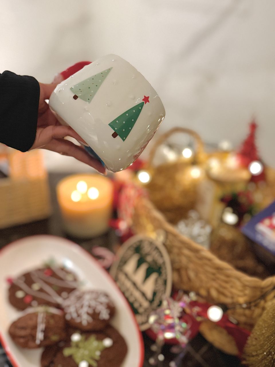Holiday gift basket with Christmas mug and candlelight